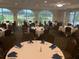 Elegant event space with set tables, refined decorations, and views overlooking the golf course at 370 Tall Oak Trl, Tarpon Springs, FL 34688