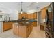 Spacious kitchen with wood cabinets, granite countertops, and stainless steel appliances at 370 Tall Oak Trl, Tarpon Springs, FL 34688