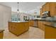 Lovely kitchen with wood cabinets, an island, and stainless steel appliances at 370 Tall Oak Trl, Tarpon Springs, FL 34688