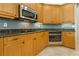 This corner of the kitchen features stainless appliances and granite countertops at 370 Tall Oak Trl, Tarpon Springs, FL 34688