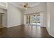 Spacious living room with wood floors, ceiling fan and sliding glass doors to the lanai at 370 Tall Oak Trl, Tarpon Springs, FL 34688
