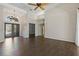 Open-concept living room featuring beautiful wood floors, double doors and soaring ceilings at 370 Tall Oak Trl, Tarpon Springs, FL 34688