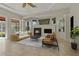 Comfortable living room with fireplace, ceiling fan, and an abundance of natural light at 370 Tall Oak Trl, Tarpon Springs, FL 34688
