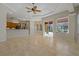 Open concept living room offering views of the kitchen and screened-in patio at 370 Tall Oak Trl, Tarpon Springs, FL 34688