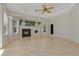 Bright living room with fireplace, ceiling fan, and an abundance of natural light at 370 Tall Oak Trl, Tarpon Springs, FL 34688