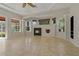 Comfortable living room with fireplace, ceiling fan, and an abundance of natural light at 370 Tall Oak Trl, Tarpon Springs, FL 34688