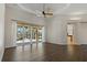 Large living room featuring wood floors, ceiling fan and sliding glass doors to patio at 370 Tall Oak Trl, Tarpon Springs, FL 34688