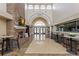 Grand lobby with soaring ceilings, brick fireplace, modern decor, and elegant entryway at 370 Tall Oak Trl, Tarpon Springs, FL 34688