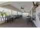 Relaxing outdoor patio area with ample seating, ceiling fans, and views of the surrounding landscape at 370 Tall Oak Trl, Tarpon Springs, FL 34688