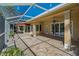 Relaxing screened-in patio with stone flooring and ample space to enjoy Florida's pleasant weather at 370 Tall Oak Trl, Tarpon Springs, FL 34688
