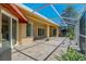 Spacious covered patio featuring stone flooring and screened enclosure with access to multiple doors and windows at 370 Tall Oak Trl, Tarpon Springs, FL 34688