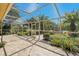 This covered patio offers a delightful view of the backyard and the surrounding lush greenery at 370 Tall Oak Trl, Tarpon Springs, FL 34688