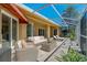 Outdoor patio area with screen enclosure and stylish patio furniture at 370 Tall Oak Trl, Tarpon Springs, FL 34688