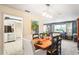 Dining room with wood table, open to living room, and an adjacent kitchen at 4615 Elwood Rd, Spring Hill, FL 34609