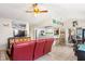 Cozy living room with an adjacent kitchen and a comfortable red leather sofa at 4615 Elwood Rd, Spring Hill, FL 34609