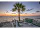 Scenic beach featuring waterfront seating, ocean views and picturesque sunset at 4712 Marine Pkwy # 104, New Port Richey, FL 34652