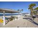 Picturesque beach area featuring covered picnic tables, palm trees and charcoal grill at 4712 Marine Pkwy # 104, New Port Richey, FL 34652