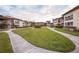 Landscaped community featuring condo buildings, sidewalks, and grassy common areas at 4712 Marine Pkwy # 104, New Port Richey, FL 34652
