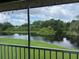 Relaxing screened balcony view overlooking lush greenery and a tranquil pond, perfect for enjoying nature's beauty at 4925 Myrtle Oak Dr # 22, New Port Richey, FL 34653
