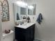 Stylish bathroom featuring a modern vanity with a sleek black cabinet, a clean white countertop, and contemporary lighting at 4925 Myrtle Oak Dr # 22, New Port Richey, FL 34653