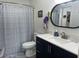 Neat bathroom featuring a vanity with modern sink and faucet, toilet, and shower with stylish curtain at 4925 Myrtle Oak Dr # 22, New Port Richey, FL 34653