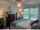 Serene bedroom with large windows offering picturesque lake views, creating a tranquil and relaxing atmosphere at 4925 Myrtle Oak Dr # 22, New Port Richey, FL 34653