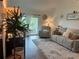 Inviting living room featuring a plush sofa, accent chair, and balcony access, perfect for relaxing or entertaining at 4925 Myrtle Oak Dr # 22, New Port Richey, FL 34653