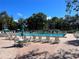 Resort-style pool area with ample seating and umbrellas, offering a perfect oasis for relaxation and recreation at 4925 Myrtle Oak Dr # 22, New Port Richey, FL 34653