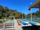 Community shuffleboard and tennis courts with well-kept grounds surrounded by mature trees at 4925 Myrtle Oak Dr # 22, New Port Richey, FL 34653