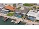 Waterfront home featuring a screened-in pool, boat dock, and beautifully landscaped yard, perfect for outdoor living at 5000 Galleon Ct, New Port Richey, FL 34652