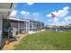 Enjoy the outdoors on the grass near your private screened-in pool by the canal at 5000 Galleon Ct, New Port Richey, FL 34652