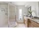Bathroom featuring marble countertop vanity, a walk-in shower with glass doors, and neutral-toned tiling at 5000 Galleon Ct, New Port Richey, FL 34652