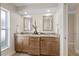Bathroom featuring dual sinks, granite countertops, and wood cabinets at 5000 Galleon Ct, New Port Richey, FL 34652