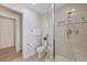 Bright bathroom features a glass shower, neutral tile, and a closet at 5000 Galleon Ct, New Port Richey, FL 34652