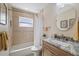 Updated bathroom with tile shower, marble countertop, and a neutral color scheme at 5000 Galleon Ct, New Port Richey, FL 34652