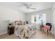 Cozy bedroom with neutral tones, a decorative bedspread, and a bright window overlooking the neighborhood at 5000 Galleon Ct, New Port Richey, FL 34652