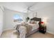 Serene bedroom with a plush bed, soft lighting, and a window providing ample natural light and waterfront views at 5000 Galleon Ct, New Port Richey, FL 34652