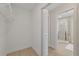 Walk-in closet leading to a bathroom with glass-enclosed shower at 5000 Galleon Ct, New Port Richey, FL 34652