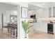Modern kitchen featuring stainless steel appliances, wine fridge, and stylish barstool seating with pendant lighting at 5000 Galleon Ct, New Port Richey, FL 34652