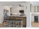 Stylish kitchen features a breakfast bar, stainless steel appliances, and custom cabinetry at 5000 Galleon Ct, New Port Richey, FL 34652