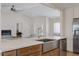 Kitchen island with sink and dishwasher, opens to living room with fireplace at 5000 Galleon Ct, New Port Richey, FL 34652