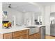 Spacious kitchen island features barstool seating, stainless steel appliances, and a view to the cozy living area at 5000 Galleon Ct, New Port Richey, FL 34652