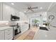 Modern, well-equipped kitchen with stainless steel appliances, white cabinetry, a breakfast bar, and water views at 5000 Galleon Ct, New Port Richey, FL 34652