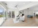 Spacious living room with fireplace, neutral decor, tile floors, and a view of the outdoor living area at 5000 Galleon Ct, New Port Richey, FL 34652