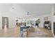 Bright open-plan living space featuring hard wood floors, modern furnishings, a ceiling fan and a seamless view to the kitchen at 5000 Galleon Ct, New Port Richey, FL 34652