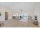 Spacious living room with tile flooring, a fireplace, and views of the pool and waterfront at 5000 Galleon Ct, New Port Richey, FL 34652
