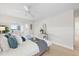 Comfortable main bedroom showcasing a bed with decorative pillows, an accent table, and sunny sitting area with canal views at 5000 Galleon Ct, New Port Richey, FL 34652