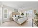 Bright main bedroom boasts a large bed with wooden headboard, stylish decor, and a seating area by the window at 5000 Galleon Ct, New Port Richey, FL 34652