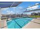 Screened-in pool area with a view of the waterfront, perfect for relaxing and enjoying the Florida sunshine at 5000 Galleon Ct, New Port Richey, FL 34652