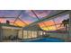 Relax by the screened pool of this waterfront home with colorful sunset view at 5000 Galleon Ct, New Port Richey, FL 34652